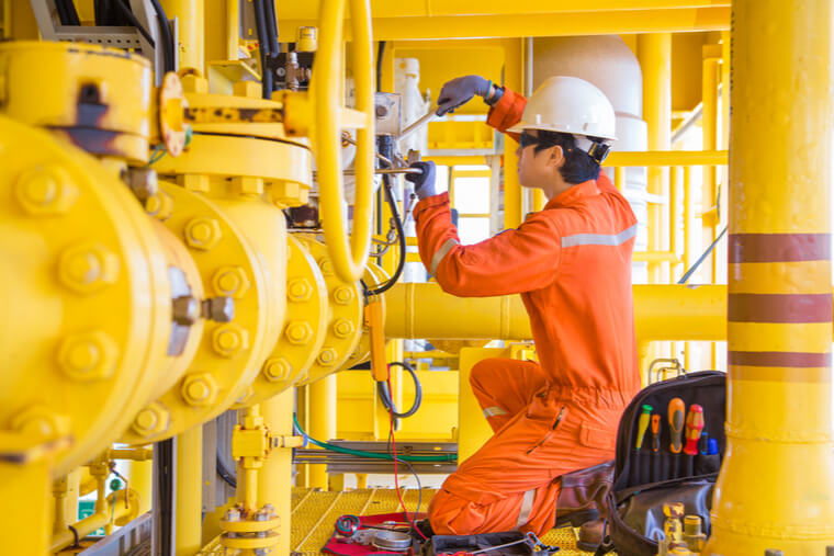 Electrical and Instrument technician fixing and replacing solenoid valve of inlet test separator shutdown valve at offshore oil and gas remote platform